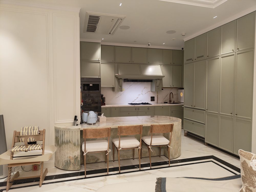 Sage green bespoke kitchen with marble island